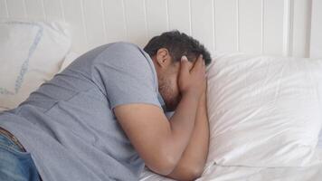 A Man Comfortably Resting on His Bed, Embracing a Pillow in a Peaceful Calm Setting video