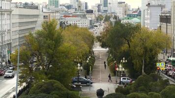 Serbia, Belgrade - September 10, 2022. Top view of alley with green trees in city center. Stock footage. Green alley in center of busy city. Intersection with cars and green alleys on background of video