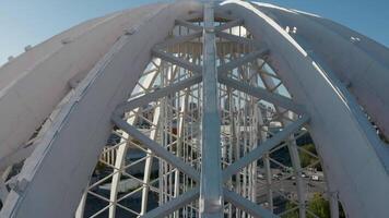 Top view of domed structure with beams. Stock footage. Beautiful architecture of metal dome with beams. Dome made of metal semi-arches with air space on background of modern city video