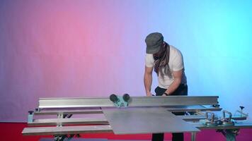 Man works at modern carpentry table. Creative. Modern carpentry table with fixing fasteners and cutters. Man is working with metal board on carpenter's table video