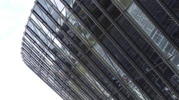 Top view of glass modern building with reflection. Stock footage. Beautiful reflection in glass facade of modern building. Glass height with landscape reflection video