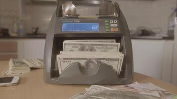 Electronic money counter machine is counting the dollar banknotes. Footage. Automatic money counting in the machine. video