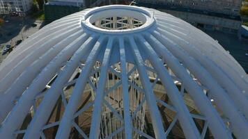 Top view of white domed structure. Stock footage. Beautiful modern building in city center in summer. Architecture of modern circus dome made of white metal arches video