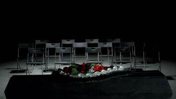Dark empty hall. Stock footage.Empty black chairs standing in a row next to the stage. video