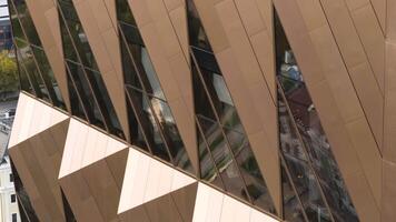 Beautiful modern building with geometric shapes. Stock footage. Top view of business center building with geometric facade. Modern architecture of high-rise video