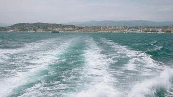 View of the blue calm sea. Action. View from a moving boat that floats creating waves and the resort landscape is visible video