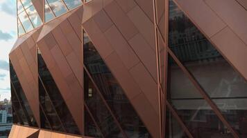 Top view of architecture of modern windows of building with reflection. Stock footage. Reflection of sky in windows of modern office building. Stylish architecture of modern building with reflection video