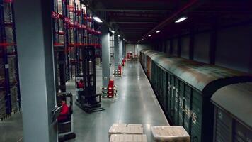 Unloading of freight trains. Creative. Parked wagons with goods in the warehouse for unloading and folding boxes. video
