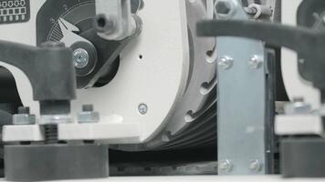 Close-up of rotating round part of factory machine. Creative. Rapidly rotating part on steel conveyor machine. Rotating steel part of machine at factory video