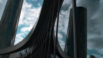 Modern building with glass windows and reflection. Stock footage. Modern architecture of glass buildings for offices or cultural museums. Beautiful reflection of buildings and sky in windows of modern video