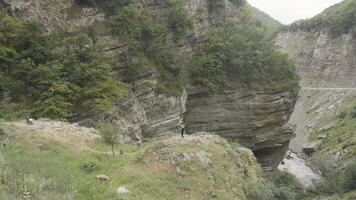 Aerial view of rocks on a summer day on a cloudy sky background. Action. Green forested mountains. video