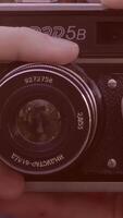 Male hand rotate the camera lens. the photographer sets up the camera before shooting. the operator changes the focus on the camera. Hand hold a camera lens video