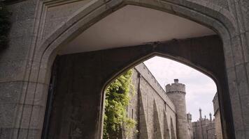 Wide gate to the ancient stone fortress. Action. Beautiful old stone high walls on a cloudy sky background. video
