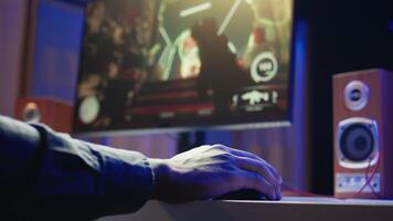 Gamer playing FPS cyberspace videogames on PC monitor using computer peripherals. Close up shot of man using keyboard and mouse, playing online games on computer at desk, having fun, camera B video