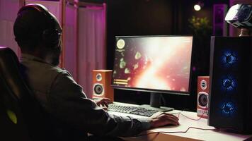 Man using headphones to enjoy online multiplayer spaceship videogame with friends, close up. Player communicating with teammates through headset mic, flying spacecraft, camera B video