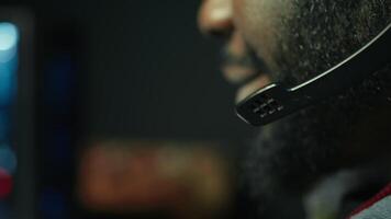 Man wearing headphones on while playing videogames at home to better immerse himself. Close up of player participating in online multiplayer esports tournament, fighting to defeat enemies, camera B video