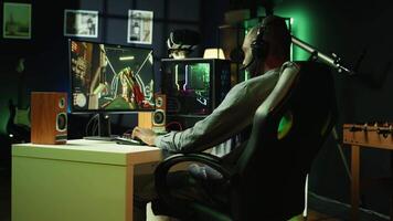 Man face palming in front of computer display while playing videogames on gaming PC, receiving game over. Gamer feeling upset after being defeated by rival players in esports tournament, camera B video