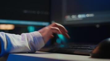 Programmer typing on computer to fix vulnerabilities in software enabling attackers to compromise systems. Woman taking care of security exposures in operating system, writing code, camera Bclose up video