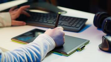 Photo editor using graphic tablet to edit color balance, delivering appealing photographs for magazines. Close up on graphic designer using stylus on touchscreen device to modify images, camera A video