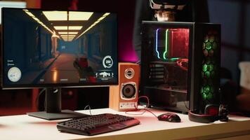 Man arriving at home to play videogames on gaming PC at computer desk, enjoying day off from work. Gamer entering room, battling enemies in online multiplayer shooter, camera A video
