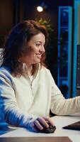 Vertical Joyous woman doing software quality assurance celebrating after reading source code and finding no errors. Cheerful engineer excited after inspecting coding on desktop PC, seeing no issues, camera B video