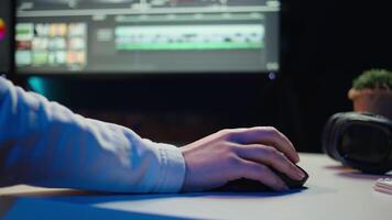 Extreme close up shot of editor selecting key frames to use while doing montage, working from home on computer. Woman using mouse to edit movie project footage in studio, camera B video