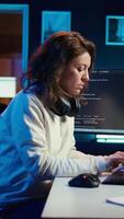 Vertical Teleworking computer technician typing on keyboard, implementing security measures to protect company systems and data, close up. Remote IT employee at home debugging code for software, camera B video