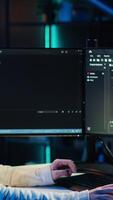 Vertical Teleworking system administrator futureproofing company network from downtimes and unexpected failures. Remote IT employee typing on keyboard, increasing data security, camera A video