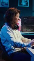 Vertical Programmer teleworking from own apartment filtering malicious traffic from cybercriminals attempting to corrupt company data using computer, preventing phishing attacks, camera B panning shot video