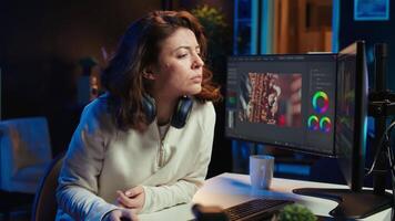 Happy videographer using professional software to create visual effects for projects, proud of results. Smiling expert using post production techniques to edit raw clips footage, camera B video