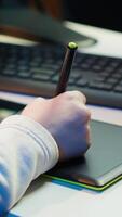 Vertical Photo editor using graphic tablet to edit color balance, delivering appealing photographs for magazines. Close up on graphic designer using stylus on touchscreen device to modify images, camera A video