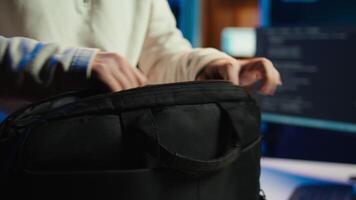 Computer scientist unpacking laptop bag, preparing to design and develop software applications. IT professional starting job shift, opening notebook to do coding, camera B video