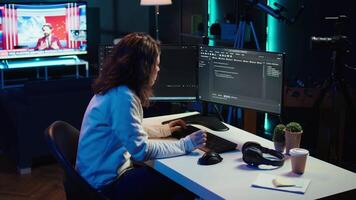 IT expert working from home developing software in JavaScript programming language using desktop PC. System engineer in living room writing lines of code on computer using keyboard, camera B video