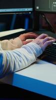 Vertical Teleworking computer technician typing on keyboard, implementing security measures to protect company systems and data, close up. Remote IT employee at home debugging code for software, camera A video
