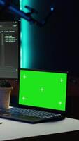 Vertical Programmer using green screen laptop to secure company servers from virus attacks. IT remote employee writing code, building firewalls protecting data using mockup notebook, camera A video