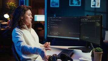 Freelancing programmer listening music while designing and developing software applications. IT specialist wearing headphones, implementing and maintaining company systems, camera B video