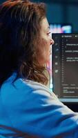 Vertical Freelancing programmer listening music while designing and developing software applications. IT specialist wearing headphones, implementing and maintaining company systems, camera A video