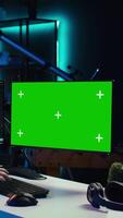 Vertical Developer doing software debugging on green screen PC at home, checking lines of code displayed on monitors. IT professional in living room fixing coding problems on mockup computer, camera B video