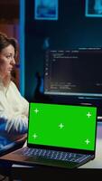 Vertical Programmer designing and developing software applications using isolated screen laptop. IT professional implementing and maintaining company systems using mockup notebook, camera B video