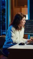 Vertical Programmer stretches body limbs after securing company servers from virus attacks all day. Fatigued IT remote employee relaxing tense muscles at desk after building firewalls protecting data, camera A video