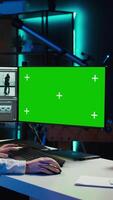 Vertical Woman using professional software on mockup PC to create visual effects for projects. Specialist using post production techniques to edit raw clips footage on green screen computer, camera B video