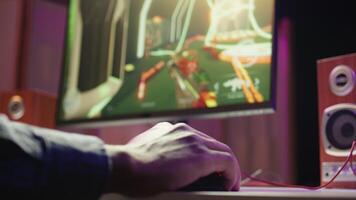 Gamer using keyboard and mouse to play FPS singleplayer videogame on PC, enjoying leisure time. Person in apartment at night using high tech computer peripherals to destroy enemies, camera B close up video