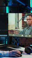 Vertical Woman doing software debugging helped by coworker in videocall, checking errors in lines of code. Programmer working from home fixing coding mistakes, assisted by colleague in teleconference, camera A video