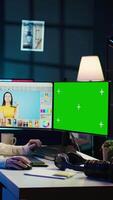 Vertical Content specialist uses graphic design skills to make social media post on green screen computer for advertising company. Photo editor using chroma key PC monitor to create promotional image, camera B video