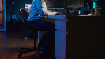 Programmer stretches body limbs after securing company servers from virus attacks all day. Fatigued IT remote employee relaxing tense muscles at desk after building firewalls protecting data, camera B video