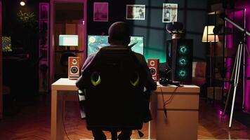 Man feeling cheerful while playing SF videogame on computer desktop, celebrating victory. Cheerful gamer overjoyed after winning game on gaming PC dolly in shot, camera B video