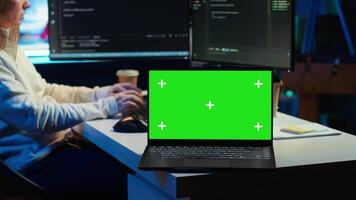 Programmer designing and developing software applications using isolated screen laptop. IT professional implementing and maintaining company systems using mockup notebook, camera A video