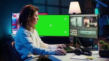 editor using editing software on green screen monitor to upgrade footage shot, commissioned by production teams outsourcing tasks. Freelancer videographer finishes project on mockup PC, camera A video
