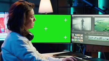 editor analyzing film montage on isolated screen display, editing color grading in office. Post production studio employee working with raw footage on chroma key PC, camera A video