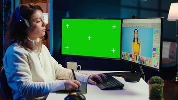 Photo editor using green screen monitor to color correct photographs in creative studio, listening music. Photographer selecting best pictures for editorial content with chroma key computer, camera B video